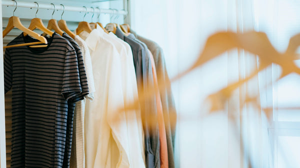 selective focus photography of shirts hanging on rack